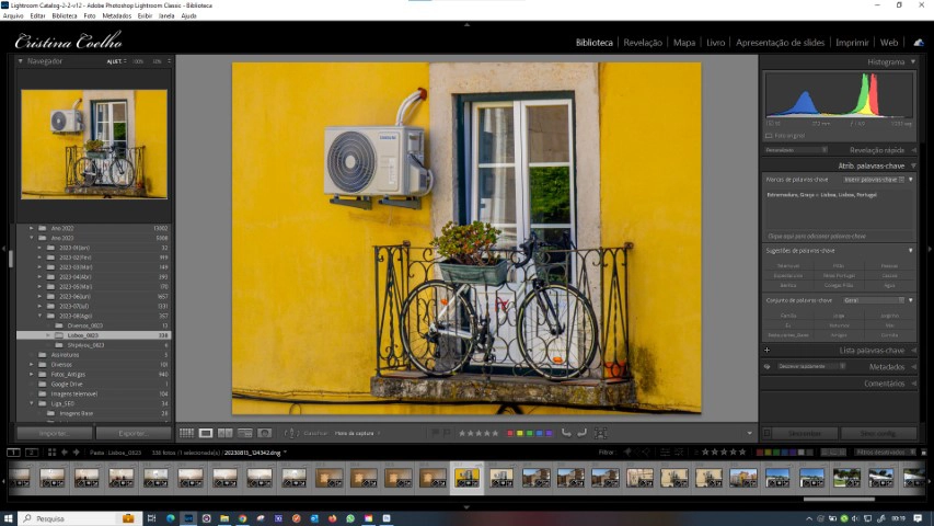Photo of a yellow building with a bicycle on the balcony, transformed using Lightroom.